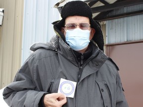 Bob Drynan displays a sticker he received at Friday's clinic indicating he received his first dose of the COVID-19 vaccine. The Porcupine Health Unit held the clinic for Timmins residents ages 80 and over at the Mountjoy Arena.

RICHA BHOSALE/The Daily Press