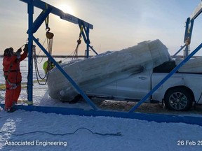 Workers with Big Ice Services lift a truck that had fallen through the Des Rocher River near the Fort Chipewyan Winter Road. Image supplied by Ray Rossington