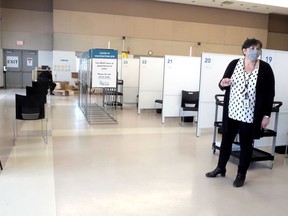 Mary Van Den Neucker, program manager at Southwestern public health, leads a tour of the health unit's mass immunization clinic in Woodstock. (Chris Abbott/Norfolk & Tillsonburg News)