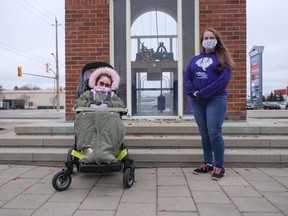 Hollie Hartford, left, and Elizabeth Sinclair-Reece marked Epilepsy Awareness Day last Friday at the Rotary Clock Tower in Tillsonburg. At Sinclair-Reece's request, the clock was lit with purple lights in honour of the day. (Chris Abbott/Norfolk and Tillsonburg News)