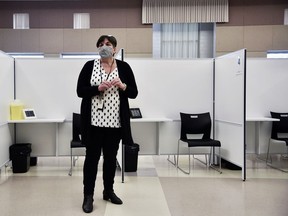 Mary Van Den Neucker, program manager for Southwestern public health, said there are 24 vaccination "pods" or stations at Woodstock's Goff Hall vaccination site. They were designed to be easily turned over and disinfected as people move through the vaccination process. (Kathleen Saylors/Sentinel-Review)