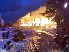 The Meaford and Blue Mountains fire departments battled a barn blaze at the corner of Highway 26 and Christie Beach Road through the night Monday as the Ontario Provincial Police were called in to shut down the highway. (Photo by Mike French Meaford Fire Department)