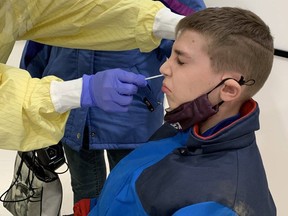 Alexander Ainscow-Gillespie gets swabbed during voluntary asymptomatic COVID-19 testing at Aylmer's East Elgin secondary school on March 10, 2021. London Free Press file photo