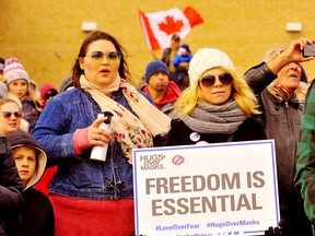Many attending a large protest in Brantford Saturday are worried that public-health measures in response to the COVID-19 pandemic are conditioning Canadians to accept the permanent loss of civil liberties. Holding the sign at right is Rachel Fleurelling of Mississauga. – Monte Sonnenberg