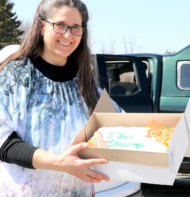 Franceline Burton holds a cake celebrating a year of praying the rosasry during the COVID-19 pandemic on Saturday, April 3, 2021 in Sault Ste. Marie, Ont. (BRIAN KELLY/THE SAULT STAR/POSTMEDIA NETWORK)