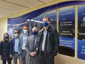 Photo illustration by ROB LOZIER of SIGN RITE 
Stephanie MacLeod - of Cameco logistics; Sanjeen Kumar - hospital chief financial officer; Jeremy Stevenson - St. Joseph’s General Hospital’s CEO; William Elliott - St. Joseph’s Foundation chair; and Terry Davis - plant manager of Cameco’s Blind River operations. For safety reasons their photo was merged with the image of the hospital’s Donors Recognition Wall.