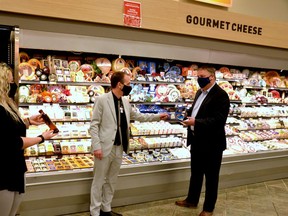 Zehrs Stratford assistant manager Kristal Carson and store manager Travis Gowland show Stratford Mayor Dan Mathieson the store's new cheese wall - one of the store's many new features following a months-long indoor renovation - following a grand re-opening ceremony inside the store Friday morning. (Galen Simmons/The Beacon Herald)