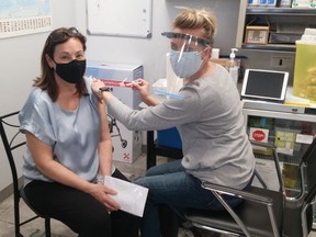 Southampton resident Judy Mitchell was uncertain about her reaction after receiving a COVID-19 vaccination from Kristen's Pharmacy owner/pharmacist Kristen Watt April 7 in Southampton. [Frances Learment]