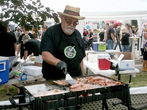 In this file photo from Lucan's 2019 Baconfest,  Lucan's Alex Hyde, representing Ontario pork producers, made sure the bacon was fried just right. Organizers recently announced that this year's Baconfest is cancelled for the second year in a row due to the pandemic. The event is due to return in 2022.