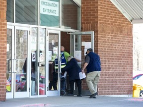 People enter the COVID-19 vaccination clinic at  the Caradoc Community Centre in Mt. Brydges on March 19. Derek Ruttan/Postmedia Network