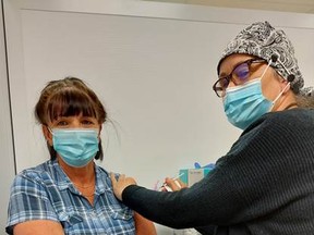 Katherine Ryder of Port Dover receives the 10,000th dose administered at the Norfolk General Hospital COVID-19 vaccine clinic. – NGH photo