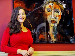 Claire Senko, program director at the Old Town Hall in Waterford, with a work by Burlington artist Lynda Jones. The exhibit 4instance runs till May 8 and is available for viewing at oldtownhall.org . – Monte Sonnenberg