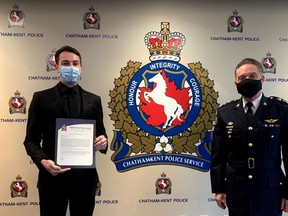 Chatham-Kent police Const. Max Bossence, left, receives a board citation from Chief Gary Conn on Tuesday. Bossence was recognized for his efforts in saving the life of a Wallaceburg stabbing victim last month. (Handout)