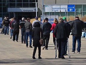 Lineups formed later in the morning for the COVID vaccine on the first day of a lower age group eligibilty at the EXPO Centre in Edmonton, April 20, 2021. Photo by Ed Kaiser.