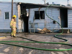 A North Bay firefighter surveys the damage to a residential unit at 1128 O'Brien Street this morning. Firefighters responded to three blazes in a 45-minute period.
PJ Wilson/The Nugget