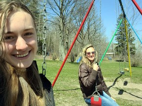 Audrey Vair and her mother, Nadine Robinson, enjoy the swings at James Lyons Park during their Earth Day cleanup.