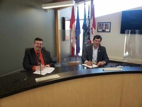 Town of Bonnyville Mayor Gene Sobolewski and Municipal District of Bonnyville Reeve Greg Sawchuk sign an intermunicpal collaboration framework agreement. PHOTO BY M.D. OF BONNYVILLE