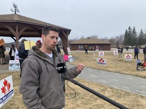 Ian Hearns, Freedom Rally supporter, talks to the local media during a protest Saturday. About 60 people attended the “Freedom Rally” at the North Bay Waterfront protesting mask wearing, testing and vaccines.