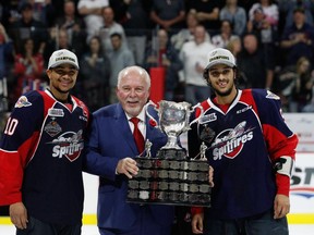 Photo courtesy CHL Images
Jeremiah Addison (left) and Jalen Chatfield of the Windsor Spitfires with OHL Commissioner David Branch, celebrate after capturing the 2017 Memorial Cup championship at the WFCU Centre in Windsor.