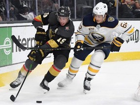 Vegas Golden Knights’ Reilly Smith, left, skates with the puck against Buffalo Sabres’ Brandon Montour in the second period at T-Mobile Arena on Feb. 28, 2020, in Las Vegas, Nevada. (Ethan Miller/Getty Images)