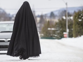A female member of the extremist Jewish sect Lev Tahor, walks down a street in the town of Sainte-Agathe-des-Monts, 100 kilometres north of Montreal, on November 26, 2013.