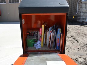Airdrie's Christina Holland recently erected the city's first Little Free Library, a book borrowing concept that brings communities together. She is hoping others get involved with their own version of the popular concept. Her Little Free Library is opened for business on Saturday August 22, 2015 in Airdrie, Alta. Dawn Smith/Airdrie Echo/Postmedia Network