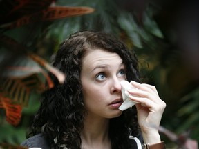 Megan Funnell, who suffers from allergies all year round, poses for photographs. Health Canada estimates that 20 per cent of Canadians suffer from allergies. Photo by John Woods/Postmedia