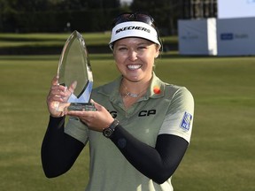 Canadian Brooke Henderson holds the trophy after winning the Hugel-Air Premia LA Open at Wilshire Country Club in Los Angeles on Saturday.