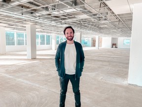 Bitcoin Well founder Adam O’Brien stands in his company's new downtown office space.