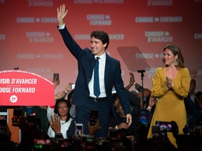 Prime minister Justin Trudeau, with his wife Sophie Grégoire Trudeau at his side, waves to his supporters at the Palais des Congres in Montreal during Team Justin Trudeau 2019 election night event in Montreal, Canada on October 21, 2019.