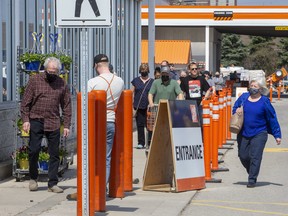 Customers line up Wednesday afternoon at the Home Depot store at Southdale and Wonderland roads to stock up before an anticipated stay-at-home order from the province went into effect. Photo taken Wednesday April 7, 2021. Derek Ruttan/The London Free Press/Postmedia Network