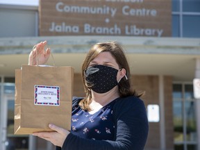 Jodi Lewis, supervisor of the Jalna Branch Library, holds a kit of crafts and activities for children the library is providing for families looking for spring break activities. Photograph taken Friday April 9, 2021. Derek Ruttan/The London Free Press/Postmedia Network