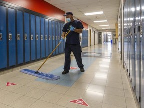 St. Thomas Aquinas custodian Dave Cabral does his rounds on Monday, April 13 at the school, which will remain closed indefinitely as Ontario schools go back online amid rising case counts during the third wave of the COVID-19 pandemic. (Mike Hensen/The London Free Press)