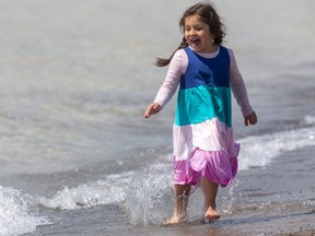 Dorothy Andrighetti, 6, runs along the edge of Lake Erie on the main beach in Port Stanley on Sunday April 18, 2021. Melissa Andrighetti said Dorothy, "doesn't feel the cold, she's always been like that," about her romping in the cold water. Mike Hensen/The London Free Press/Postmedia Network