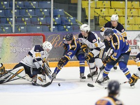 The Fort McMurray Oil Barons try to control the puck in the Spruce Grove Saints end during their game at Centerfire Place on Sunday, April 4, 2021. Photo by Dan Lines