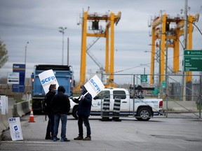 Longshore workers strike outside the Port of Montreal in Montreal, Quebec, Canada, April 26, 2021.  REUTERS/Christinne Muschi