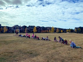 Coopers Crossing students stretch as they prepare to participate in the 2020 Terry Fox Run. Photo courtesy of Rocky View Schools