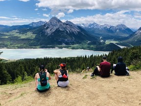 Hikers at Barrier Lake lookout overlooking Kananaskis Country in June 2020. The UCP government said in response to the five million visitors that descended on K-Country last year they have implemented a new conservation pass charging $15 per vehicle a day or $90 for an annual pass. Photo Marie Conboy/ Postmedia.
