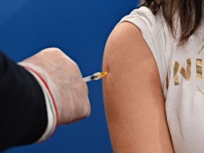 A woman in Italy receives a COVID-19 shot.