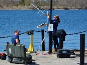 Hydrographers Jim Weedon and Lisa Ellingwood from the Canadian Hydrographic Service set up an array of electronic equipment at Meyers Pier in Belleville Wednesday that will record water levels until October. DEREK BALDWIN