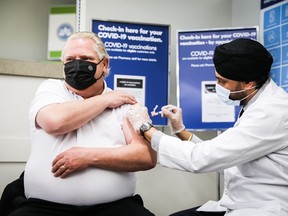 Ontario Premier Doug Ford receives his first dose of the COVID-19 AstraZeneca vaccine Friday at an Etobicoke pharmacy. OFFICE OF THE PREMIER
