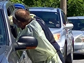 A Hastings-Quinte paramedic swabs a motorist last summer at a  COVID-19 mobile assessment centre in Tweed. Logistics and resources prevent a similar mobile approach to vaccinating people in their homes, officials say.