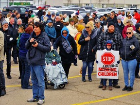 A large crowd gathers for an anti-lockdown protest in a parking lot at 195 Henry St. in Brantford on Saturday. MONTE SONNENBERG