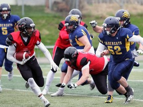 Brantford Bisons running back Matt Clarke runs away from a Sault Ste. Marie Sabercats player during an Ontario Football Conference game. Due to COVID-19 restrictions, the Bisons will offer flag football this season in place of tackle.