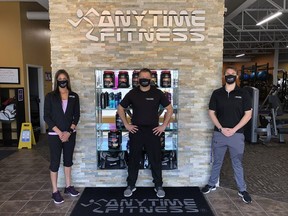 Paul Kunkel (centre), co-owner of Anytime Fitness on King George Road, with coaching manager Tammy Lalani and certified health coach Mark McCleod.