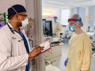 Dr. Damien Medina consults with registered nurses Jennifer Brown and Celine Bosse (right) about the care of COVID-19 patients at Brantford General Hospital. Vincent Ball/Brantford Expositor/Postmedia Network