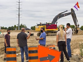 Three members of the OPP West Region provincial liaison team speak with a pair of Indigenous protesters on Tuesday in Caledonia. The protesters have shut down a residential development underway on McKenzie Road, near Fuller Road, in the community's south end.