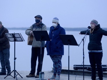 Rev. Kimberly Heath, right, of Wall Street United Church, indicates to congregants how far to distance during a COVID-cautious Easter sunrise service Sunday morning, while, from left, Richard Hennessy, Paul Bullock and Beth Kent prepare their music ministry. (RONALD ZAJAC/The Recorder and Times)