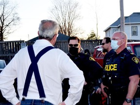 The founder of No More Lockdowns Canada, MPP Randy Hillier, confronts police at the "mask burning" event held at the South Branch Bistro in Kemptville on Thursday evening. (HEDDY SOROUR/The Recorder and Times)