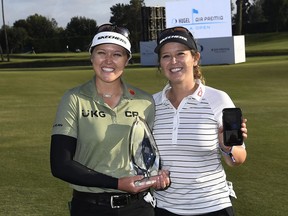 Smiths Falls native Brooke Henderson holds the championship trophy while her sister/caddie Brittany holds a mobile while doing a face time with their parents after winning the HUGEL-AIR PREMIA LA Open on Saturday, April 24.
Kevork Djansezian/Getty Images